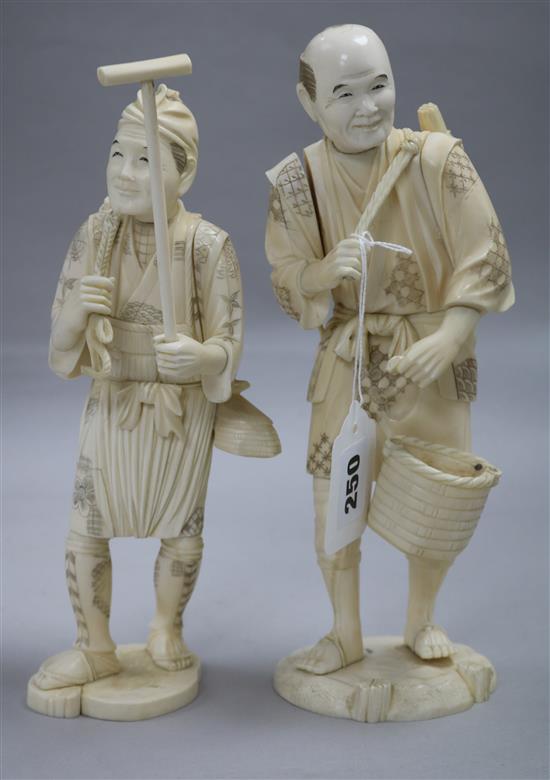 Two Japanese sectional ivory figures of farmers, early 20th century, 25 and 25.5cm